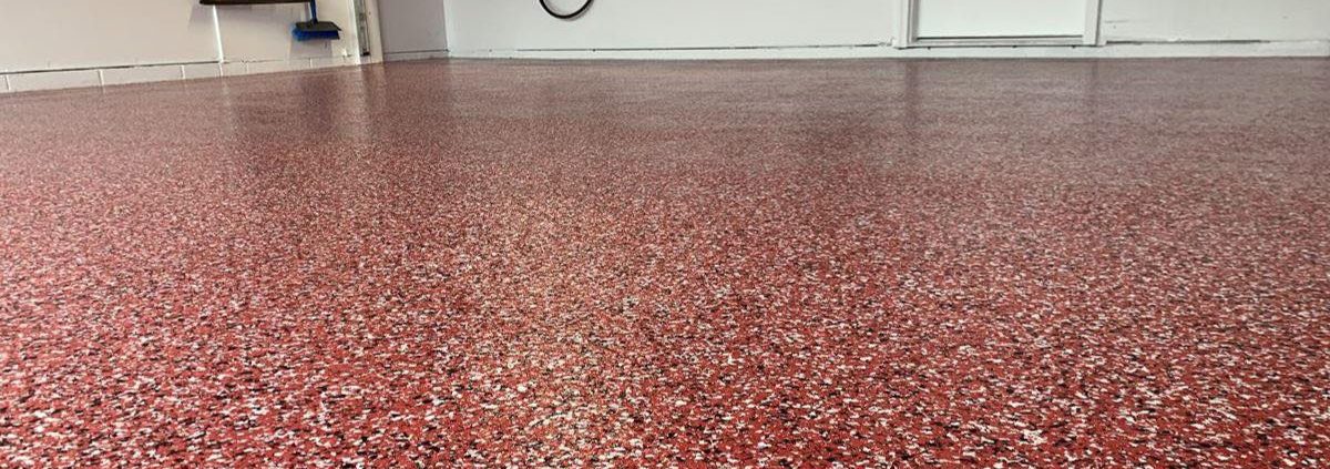 epoxy flooring with a red base and black and white flakes - Innovative Garage Flooring epoxy flooring contractor near