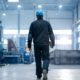 man in a factory wearing a hard hat and holding a clipboard - Innovative Garage Flooring commercial flooring solutions