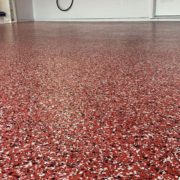 close up of full flake epoxy flooring with red flakes - Innovative Garage Flooring full flake epoxy flooring