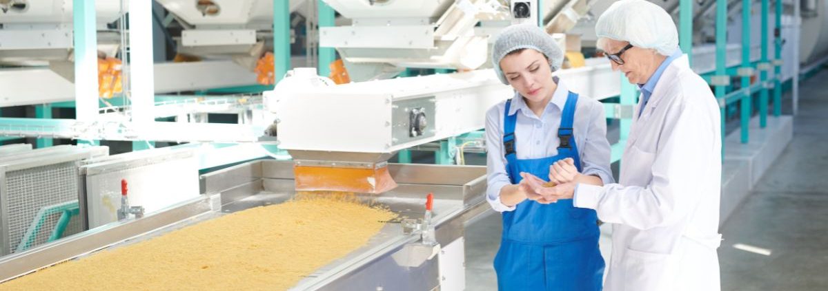 two people next two metal machine - Innovative Garage Flooring epoxy flooring for food processing facilities