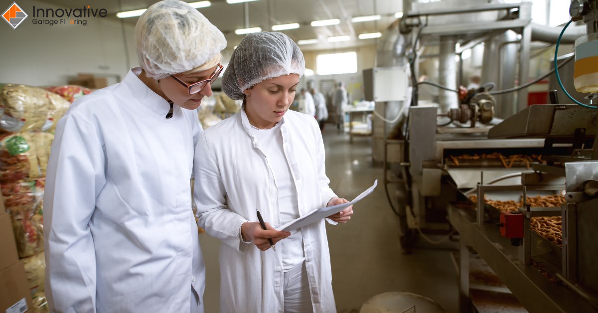 two people next two metal machine - Innovative Garage Flooring epoxy flooring for food processing facilities