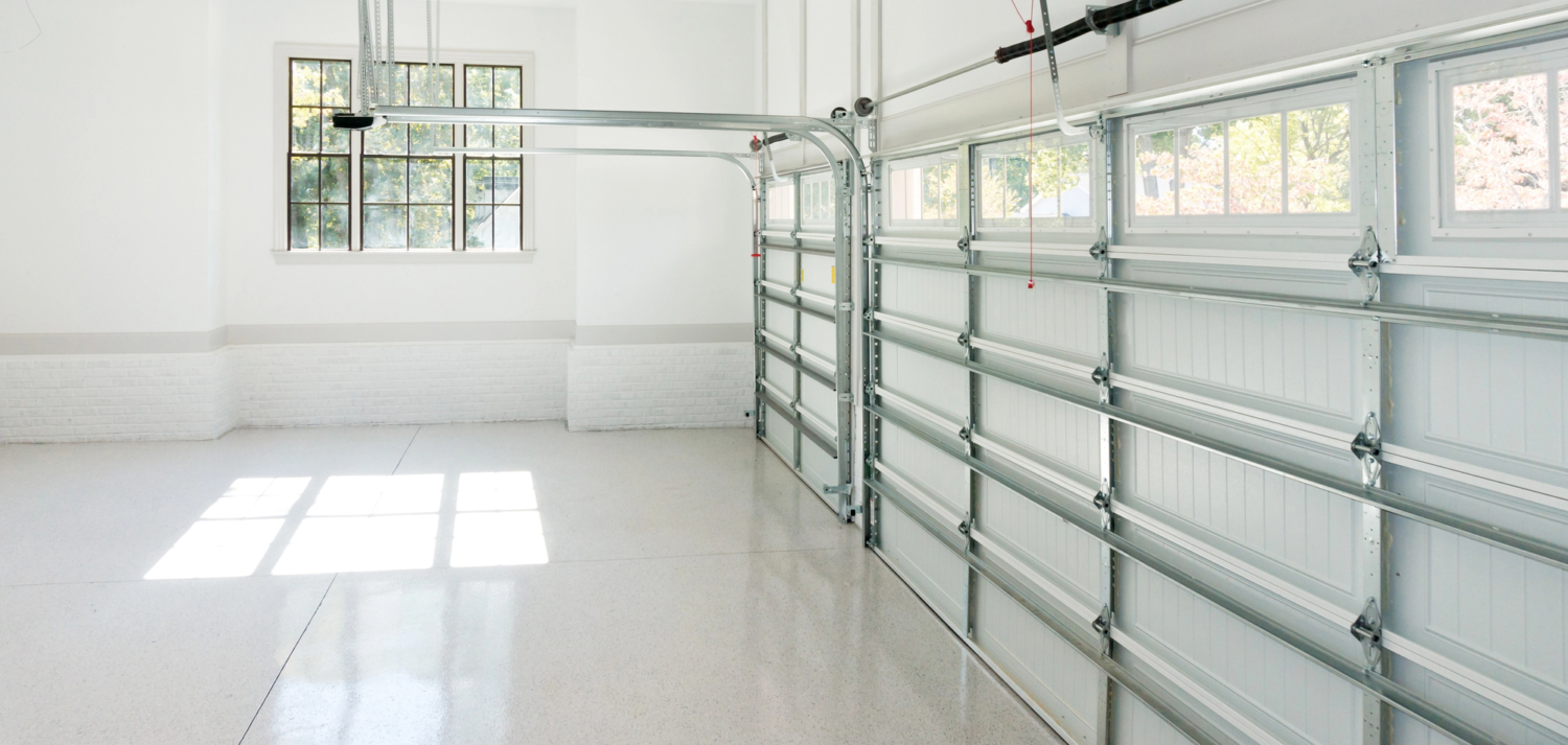 garage with a closed door and window - Innovative Garage Flooring residential flooring
