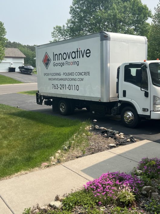 white box truck with color logo on the site - Innovative Garage Flooring